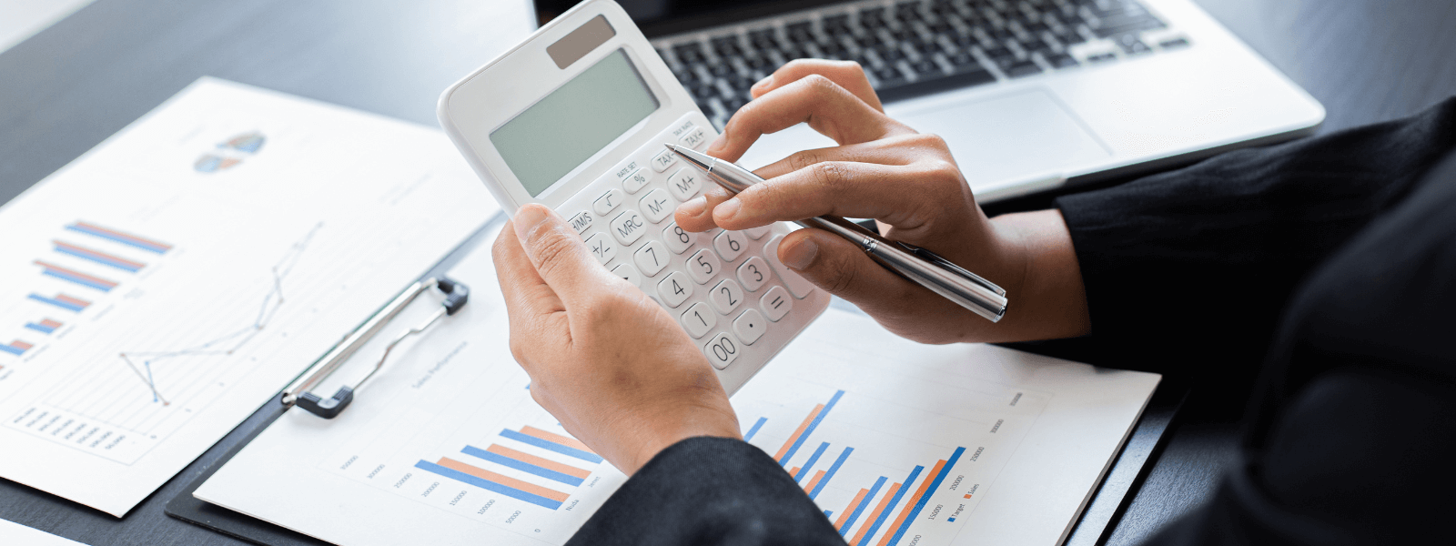 Accountant reviewing financial charts with a calculator